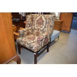 5349 Brown floral patterned wing backed armchair