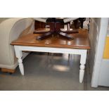 Square oak coffee table on a cream painted base