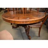 Circular Victorian walnut breakfast/supper table on a tripod base with brass castors