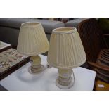 A pair of cream onyx table lamps with pleated shades