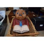 Carved and painted wooden teddy bear plus a wicker basket