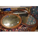 Circular early 20th century mirror in an oak frame plus an oval mirror in walnut frame