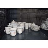 Cage containing quantity of floral patterned crockery inc. cups, saucers and teapot