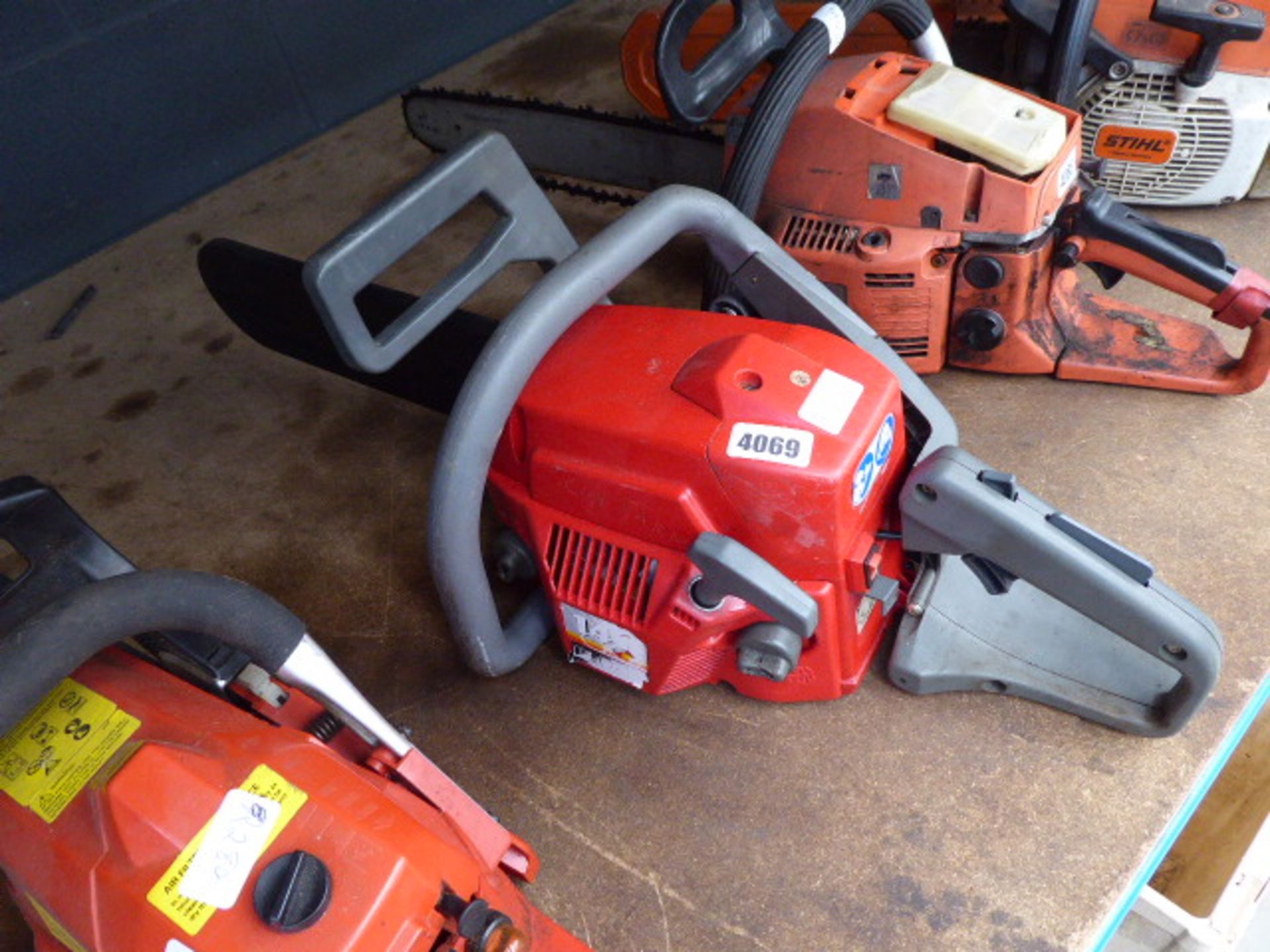 Red petrol powered chainsaw