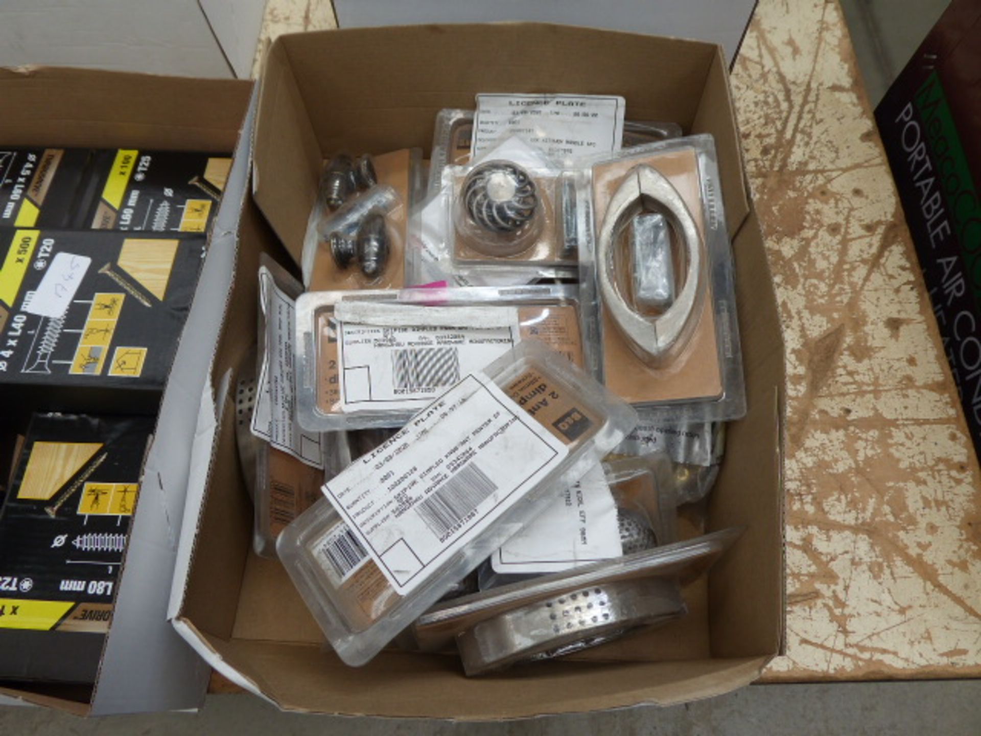 Box containing dimpled door knobs, door handles and other handles