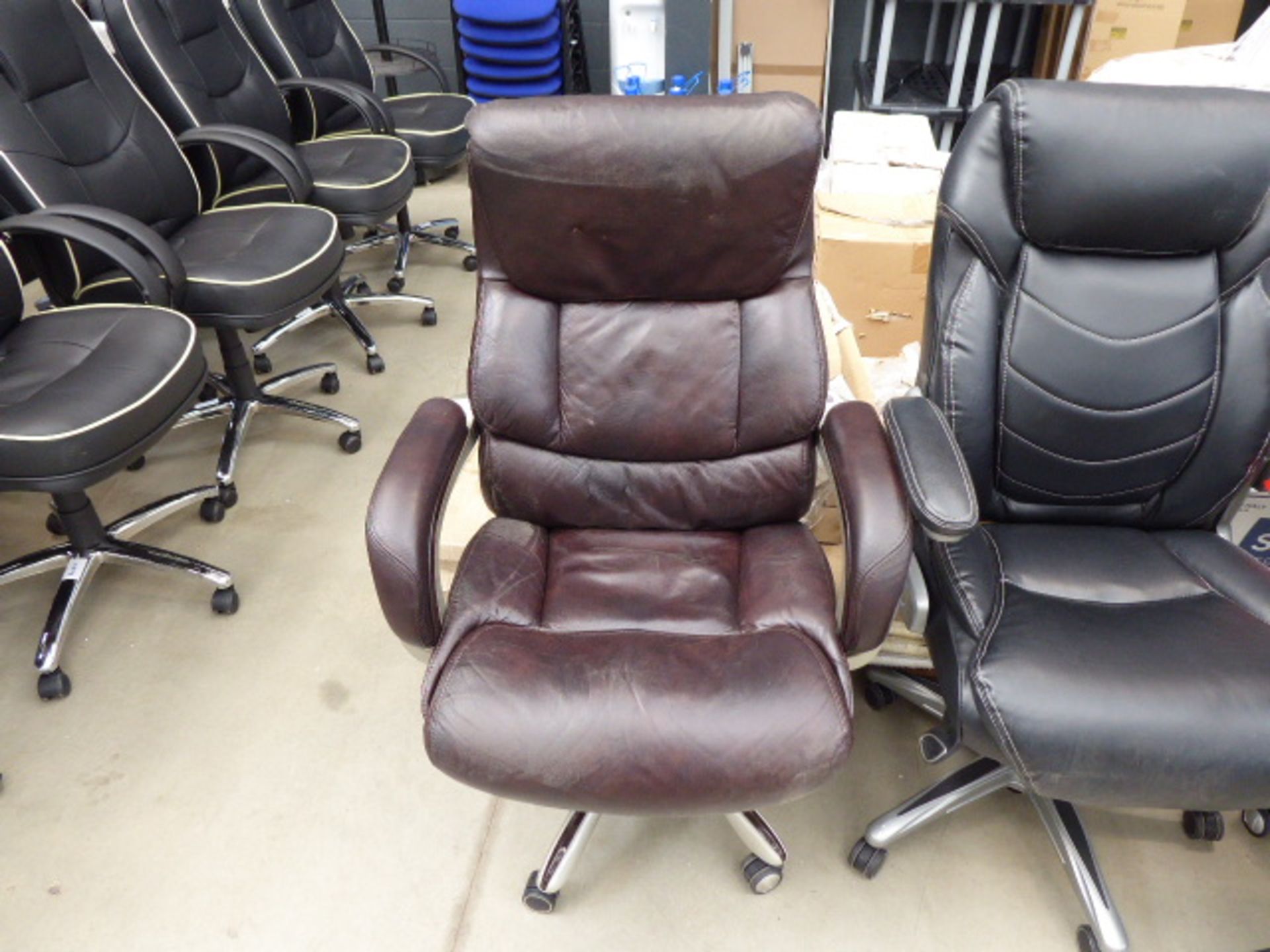 Brown high backed executive style swivel armchair