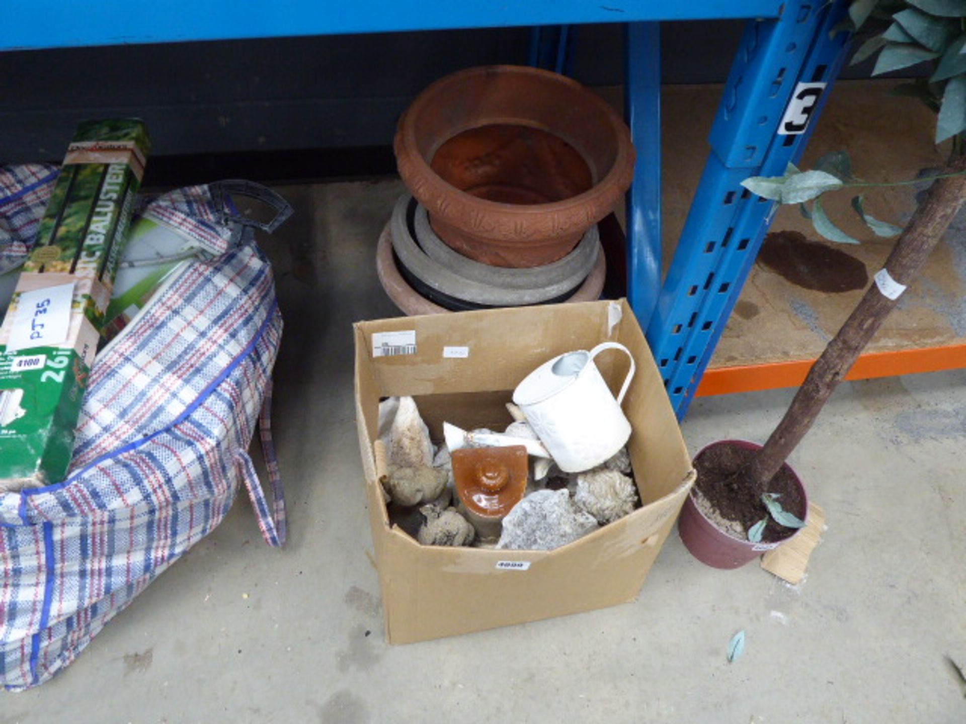 Box of garden ornaments and plant pots