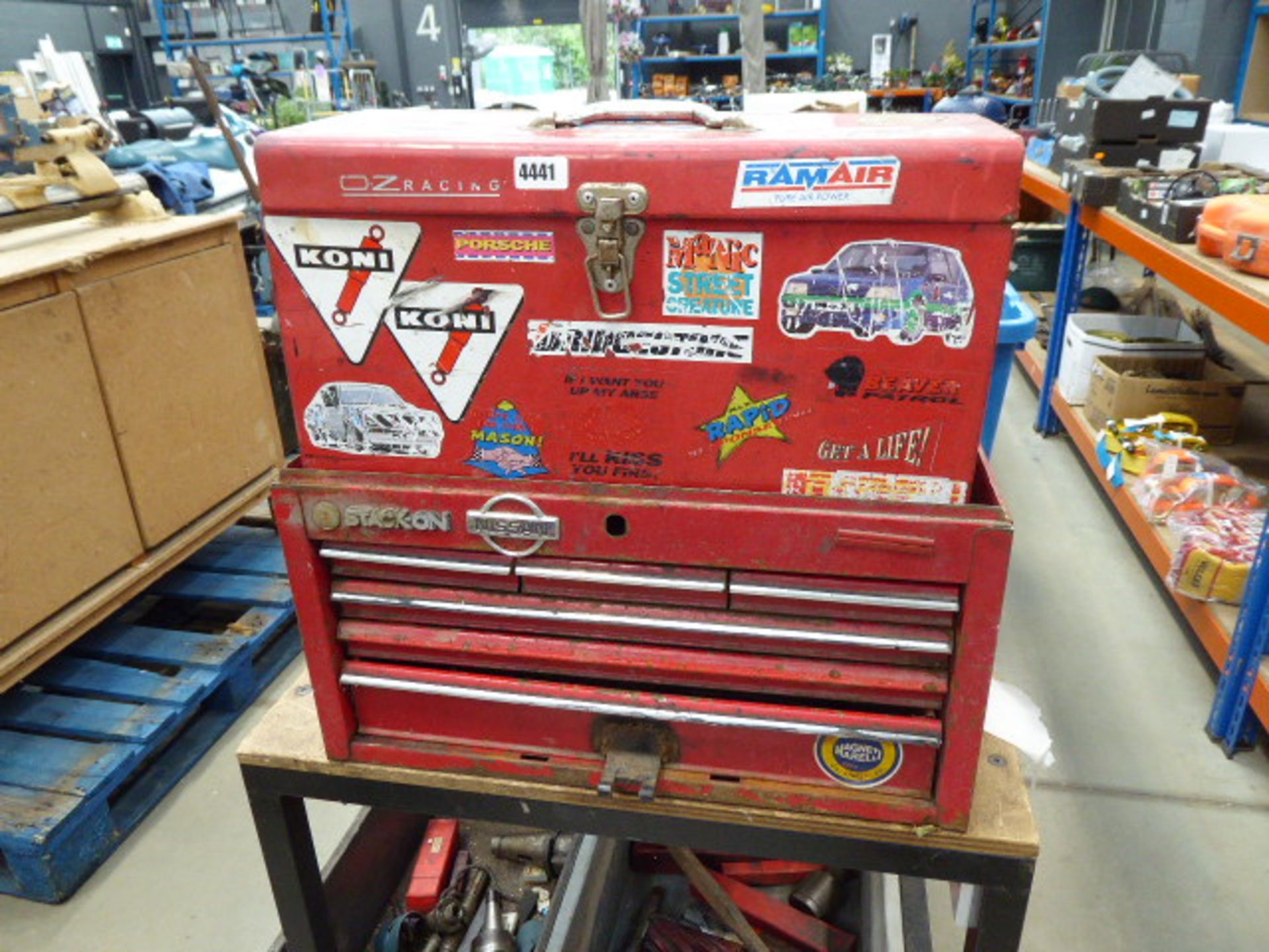 2 red metal toolboxes with small quantity of tools