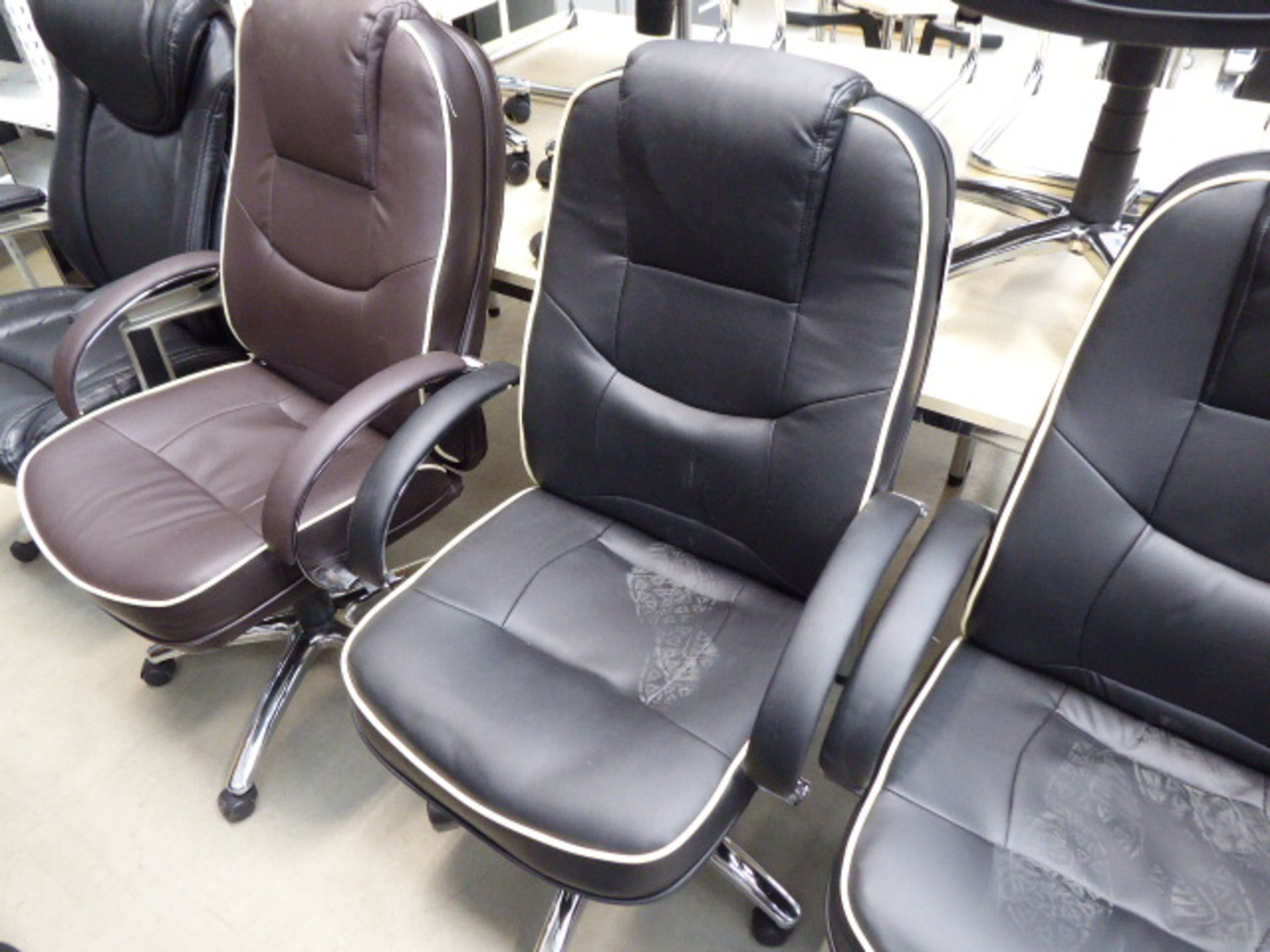 Black high-back executive swivel armchair with cream piping