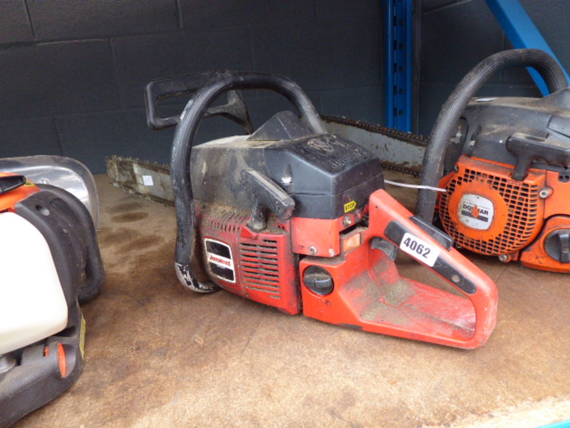 Jonsered red petrol powered chainsaw