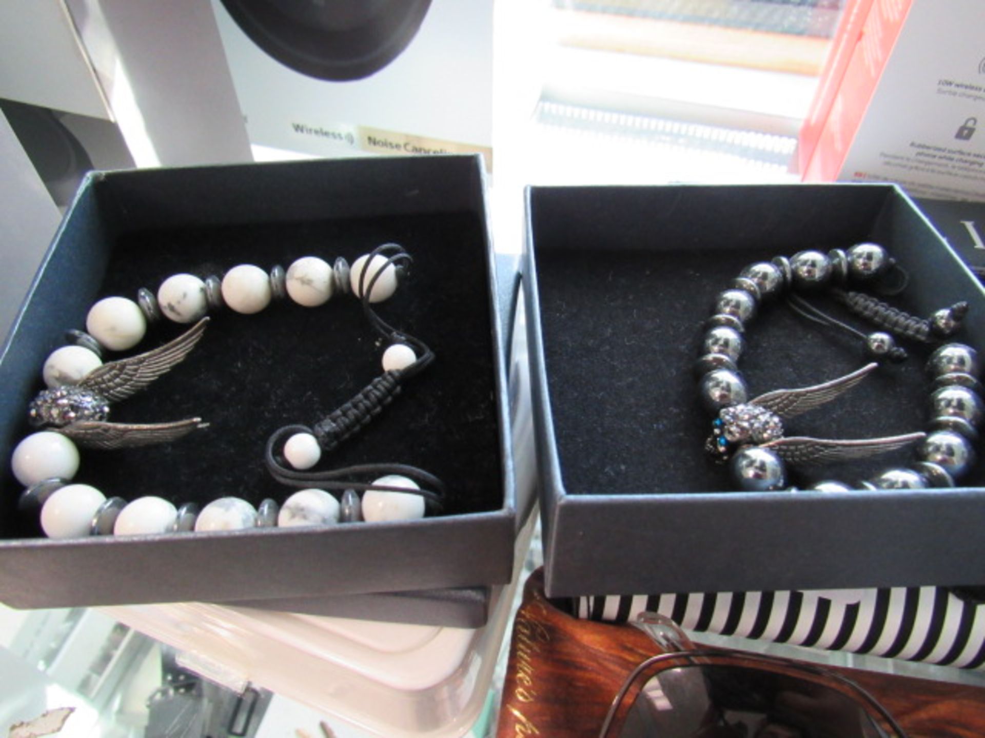 2 skull head bracelets in box