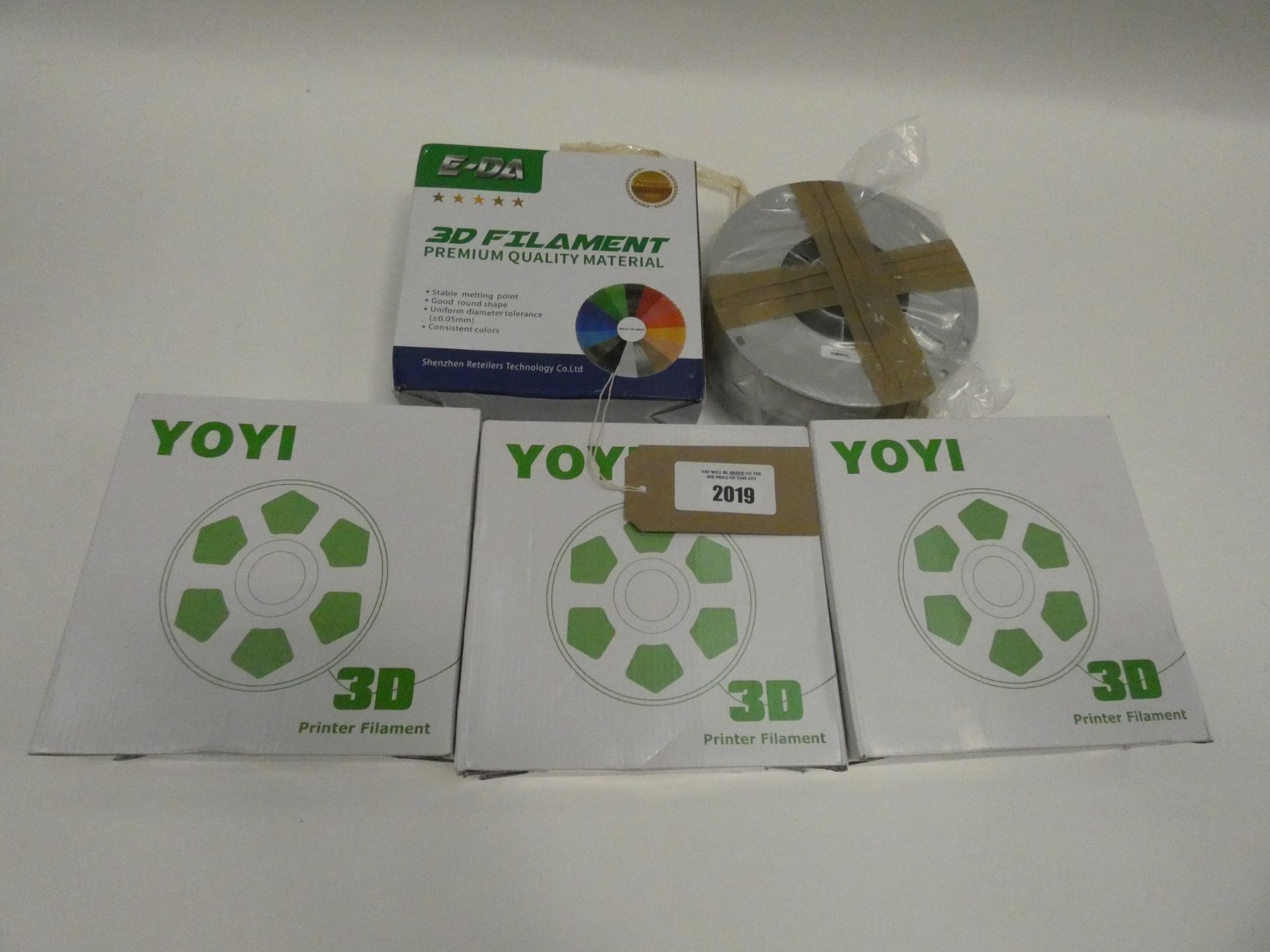 Bag containing various 3D printer filament in various colours; silver, grey and white