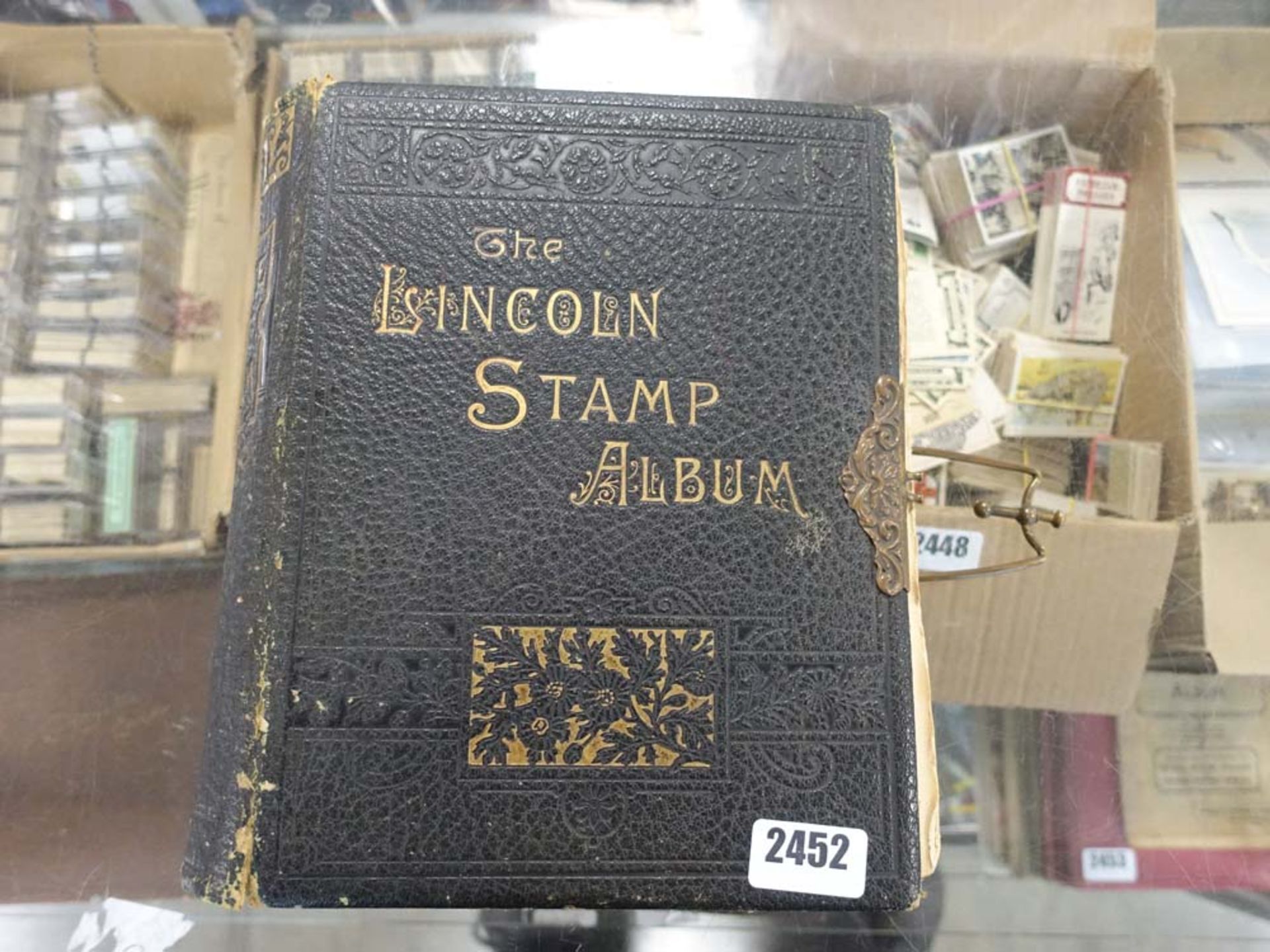 Lincoln stamp album bound with brass latch and stamp contents