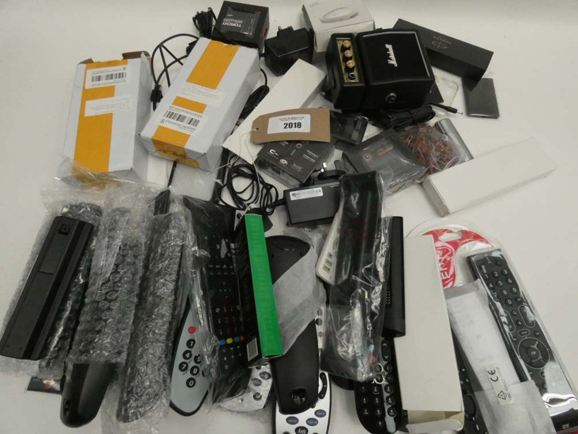Bag containing quantity of remote controls, power supply units, speaker, Parker pen, etc