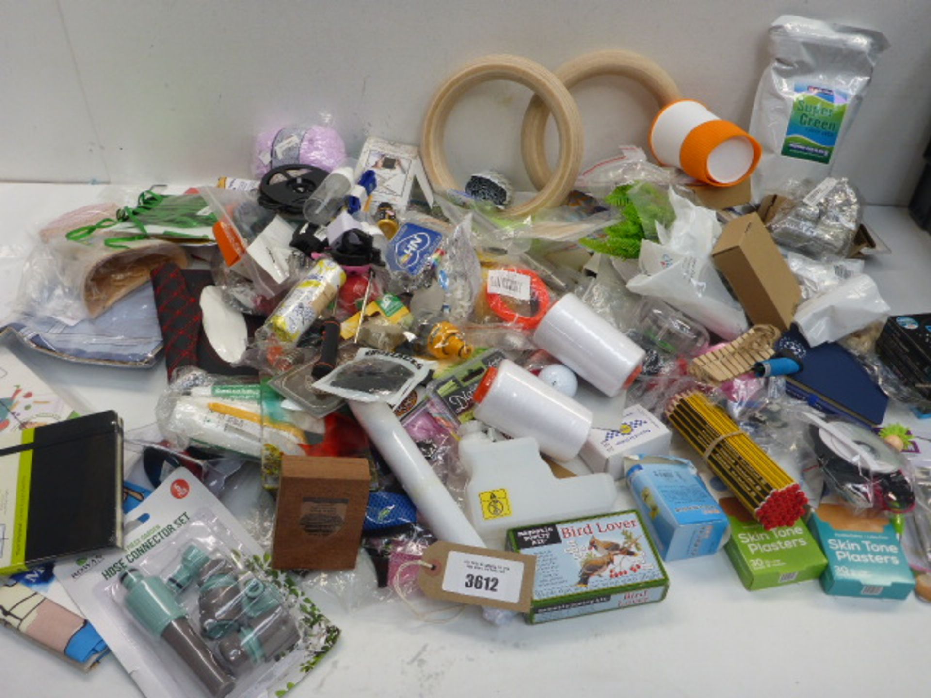 Large bag of household sundries including lawn seed, paint, hose attachments, plasters, tea towel,