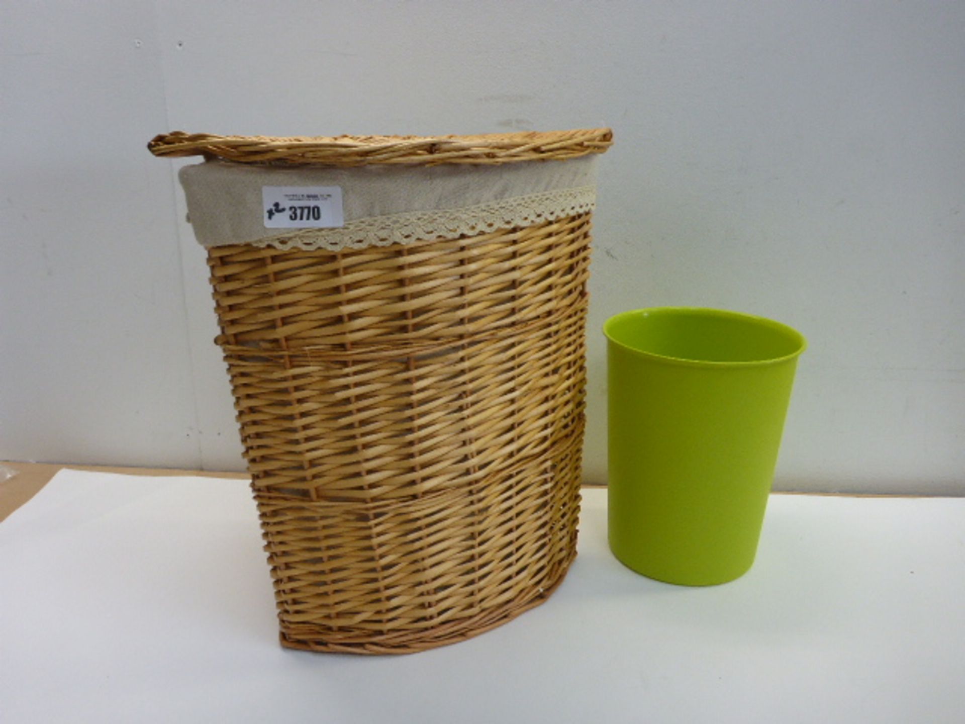 Wicker laundry basket and green waste paper bin