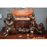 5 wooden carvings depicting children and other figures