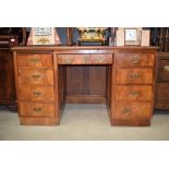 Walnut twin pedestal desk having an arrangement of 9 drawers