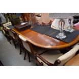 Reproduction extending dining table plus a harlequin set of 10 chairs