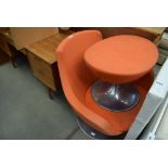 Orange fabric swivel chair with chrome base and matching footstool