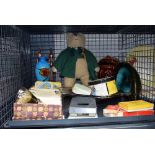 Cage containing a teddy bear, biscuit barrel, an ash tray, coloured wine glasses and general