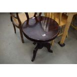 Circular dark wood tripod table
