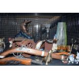 Cage containing ornamental flintlock pistols, decanter, glassware and ornaments