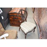 Heavily carved mahogany chair with upholstered seat