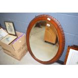 Oval bevelled mirror in dark oak frame