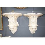 Pair of wall brackets with cherubs to the column