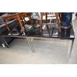 A pair of metal and black granite coffee tables