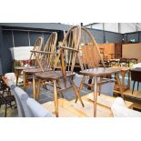 Four Ercol hoopback dining chairs to include one carver