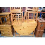 A pine dropside table and four chairs