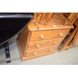 A pine chest of three drawers