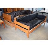 Two pine and beech tree seater sofas with black leather effect cushions