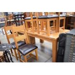 Oak extending dining table plus six leather effect chairs
