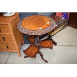 Circular carved walnut tripod table with second tier