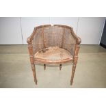 Bergere tub chair with heavily carved frame