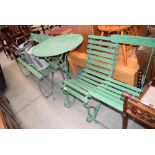 Green painted circular garden table plus a bench and two chairs