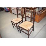 5009 Pair of heavily carved oak dining chairs with rushed seats