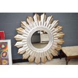 Circular mirror in silver painted sunburst frame
