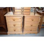 A pair of pine three drawer bedside cabinets