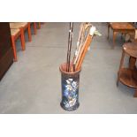 Floral decorated pottery stick stand with a quantity of walking sticks