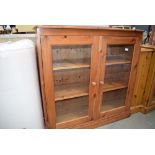 Glazed pine double door bookcase