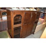 Dark oak bureau with cupboard and glazed doors to the side