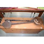 Pair of heavily carved bellows and a copper warming pan