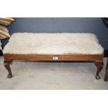 Shaggy woolen footstool on cabriole supports