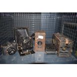 Cage containing a quantity of vintage cameras