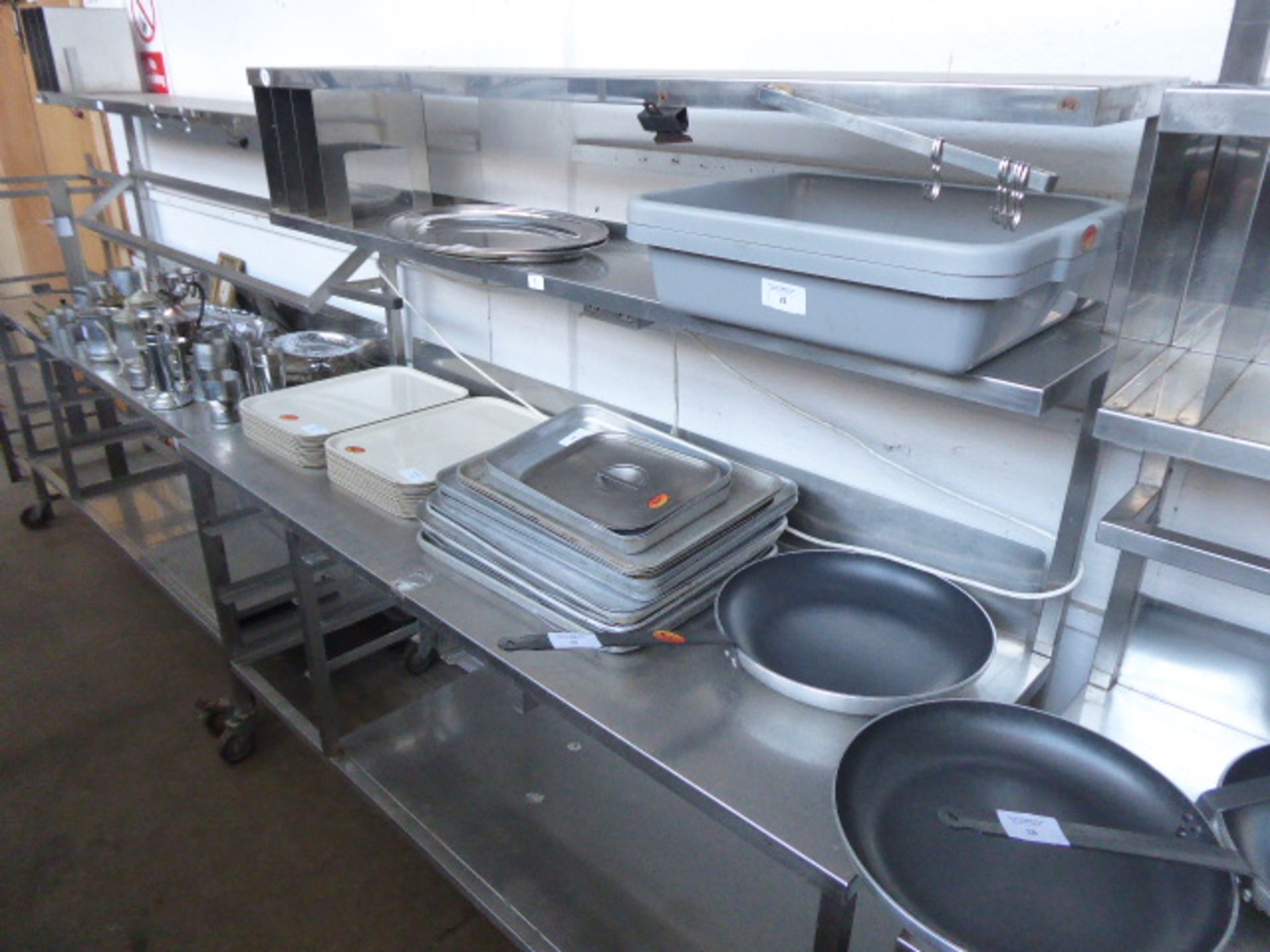 177cm Stainless steel mobile preparation station with two tiers over, shelf under on castors