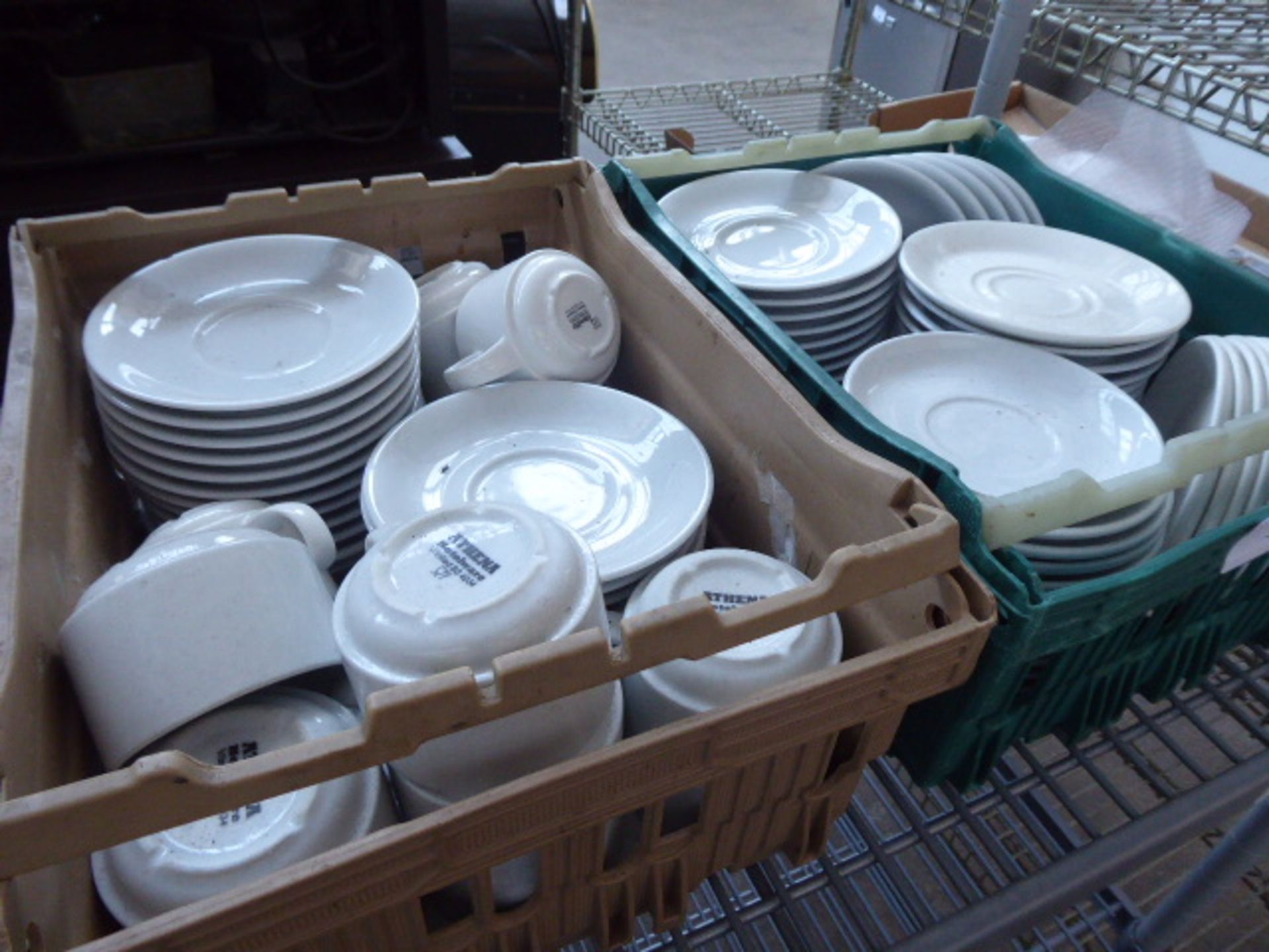 2 Plastic trays of assorted saucers side plates with a collection of cups